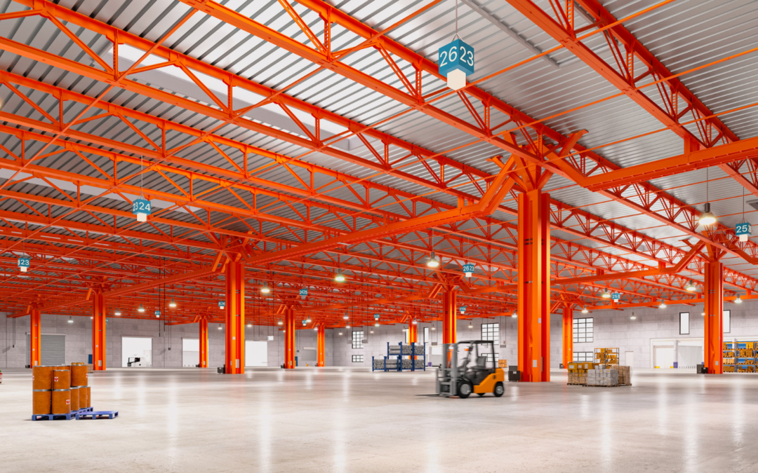 A polished concrete floor in a spacious industrial facility with heavy-duty equipment.